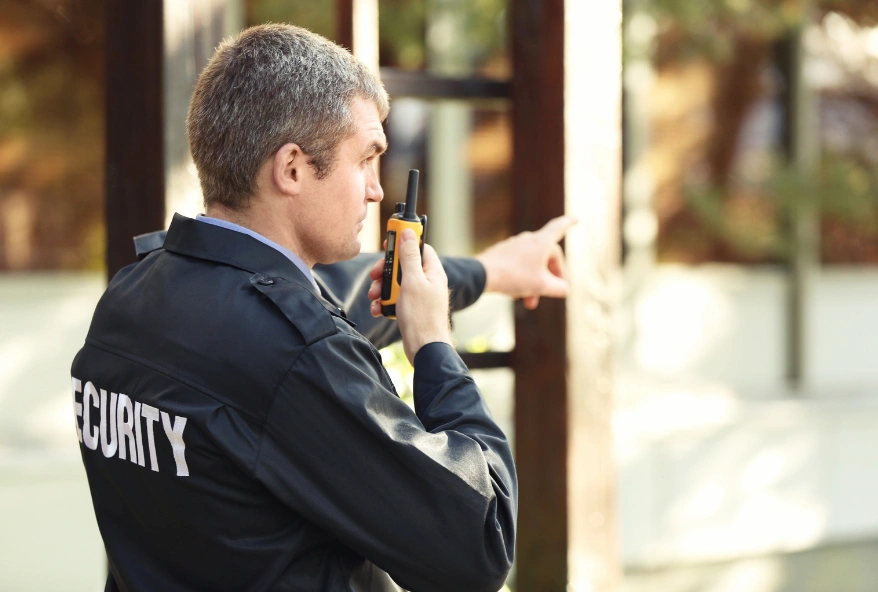 Building security services Dubai security guard monitoring a commercial property