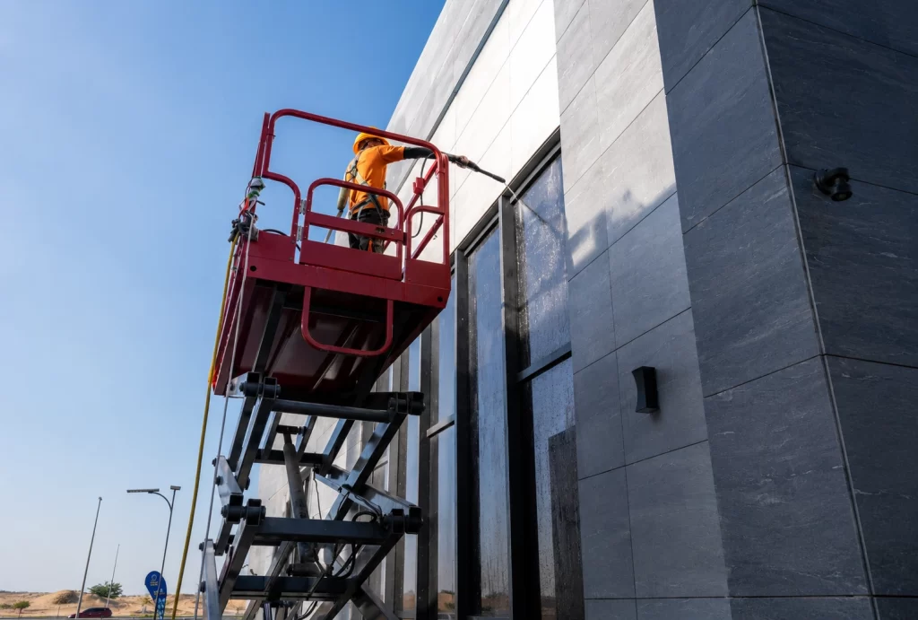 Commercial facade cleaning Dubai showing a dusty office building before cleaning