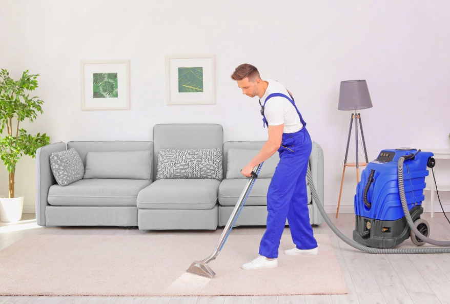 Professional cleaner performing villa deep cleaning in a modern living room.